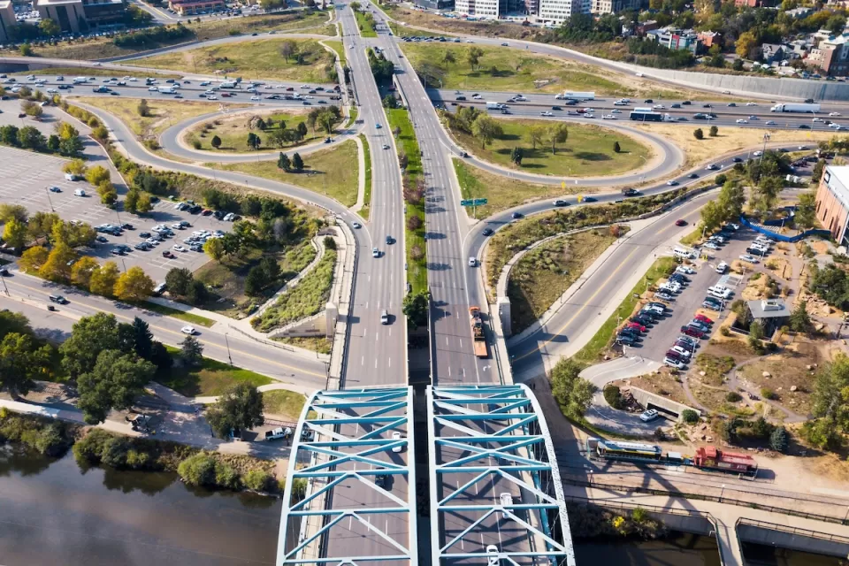 Aerial view of wide roadway and arc bridge in Denver, Colorado.
